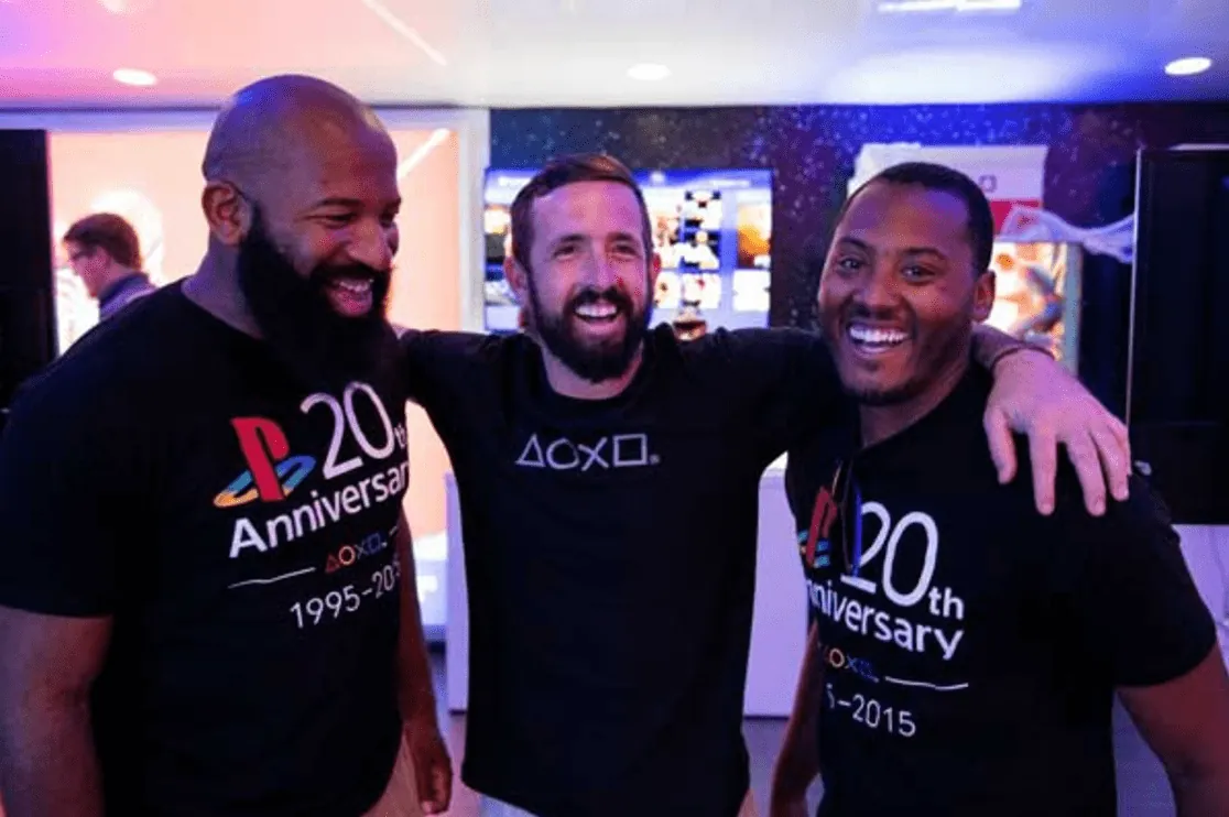 Three Playstation employees celebrating 20 year anniversary with commemorate t-shirts